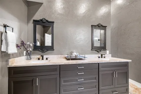 a bathroom with a double vanity sink and a mirror