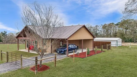 a view of a house with a yard patio and sitting area