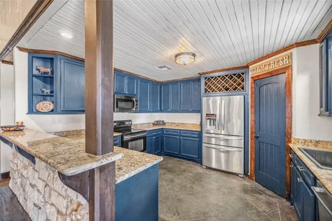 a kitchen with refrigerator cabinets and stove