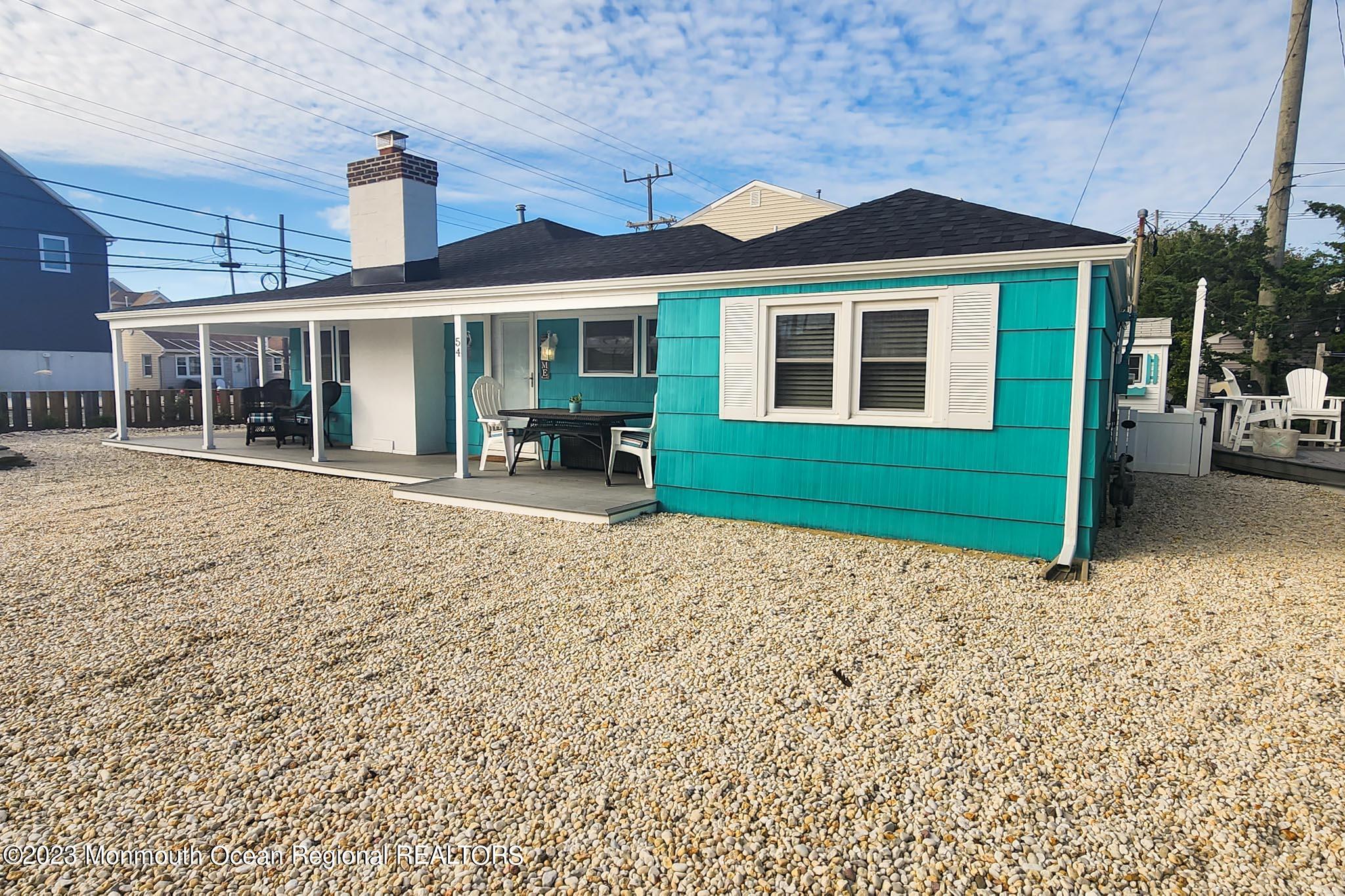 54 Silver Beach Road Lavallette, NJ 08735 - Photo 11 of 49 a front view of a house with a garden and yard