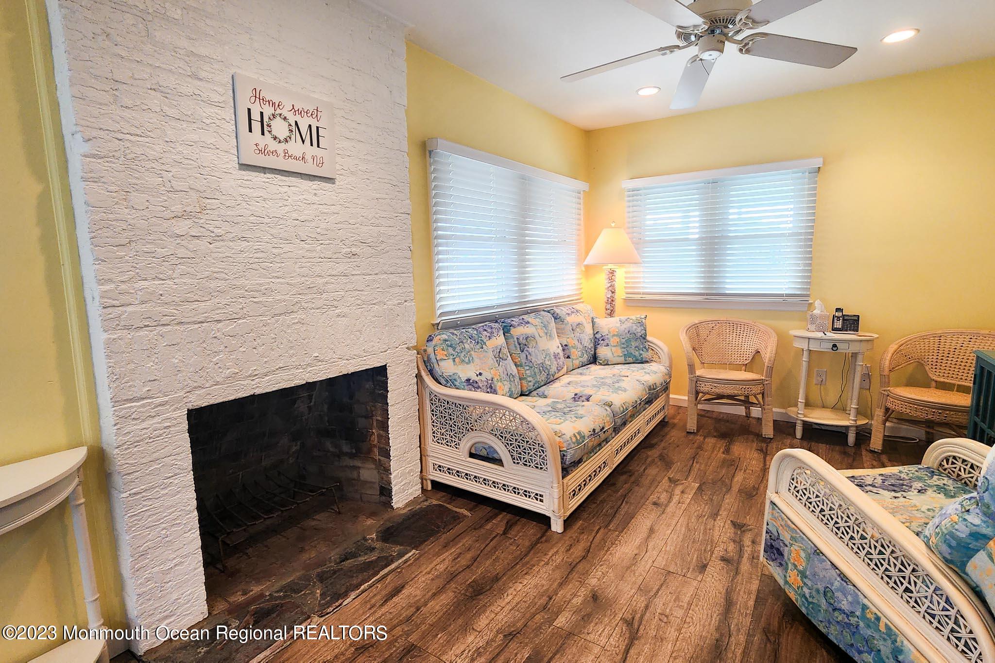54 Silver Beach Road Lavallette, NJ 08735 - Photo 17 of 49 a living room with furniture and a fireplace