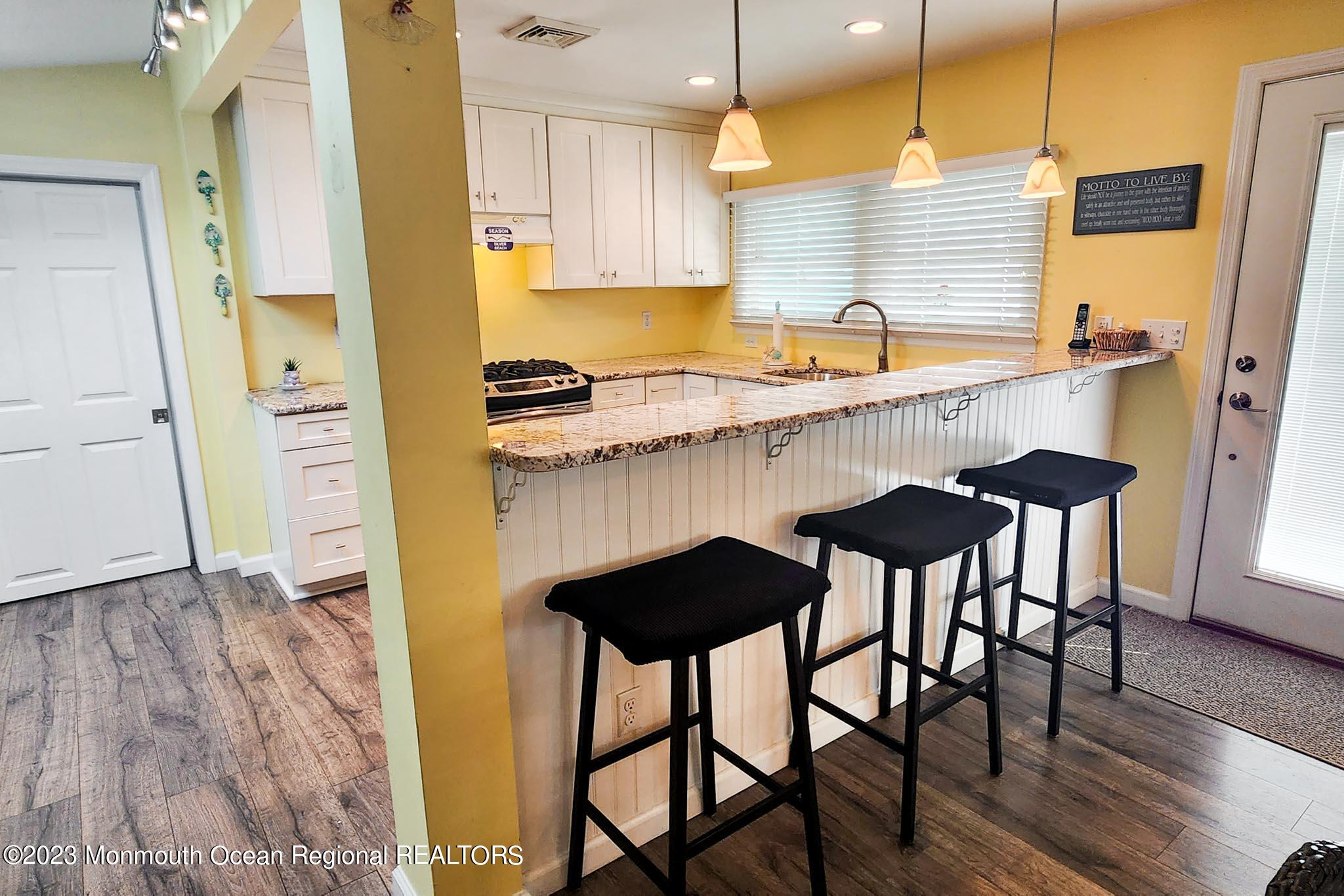 54 Silver Beach Road Lavallette, NJ 08735 - Photo 21 of 49 a kitchen with stainless steel appliances granite countertop a sink and a refrigerator