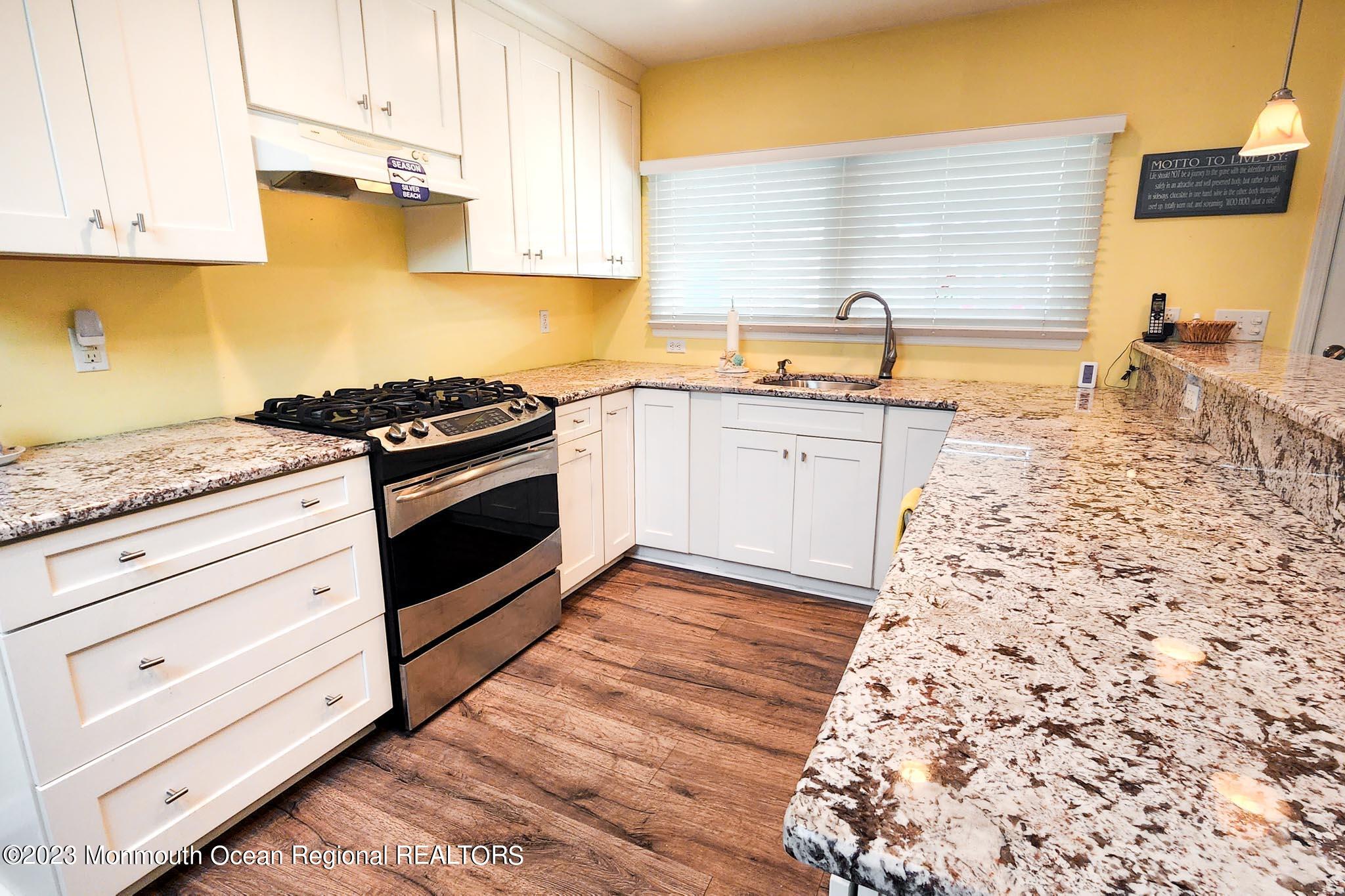 54 Silver Beach Road Lavallette, NJ 08735 - Photo 22 of 49 a kitchen with granite countertop a stove and a sink
