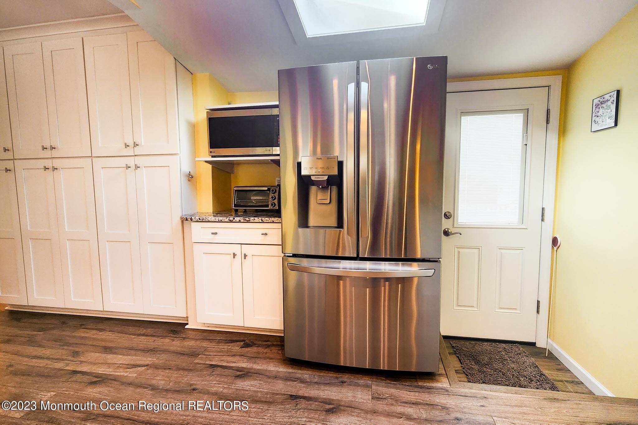 54 Silver Beach Road Lavallette, NJ 08735 - Photo 23 of 49 a view of a kitchen with wooden floor and electronic appliances