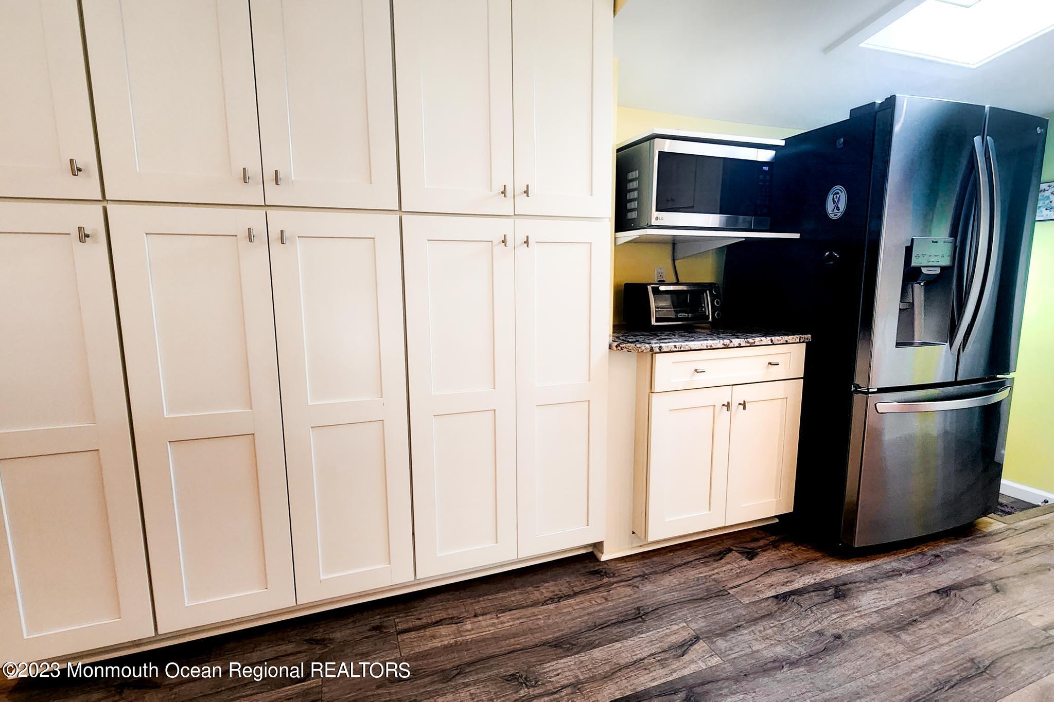 54 Silver Beach Road Lavallette, NJ 08735 - Photo 24 of 49 a kitchen with stainless steel appliances a refrigerator and cabinets