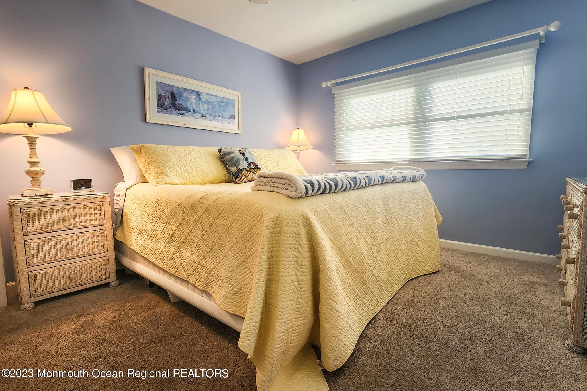 54 Silver Beach Road Lavallette, NJ 08735 - Photo 29 of 49 a bed room with a bed and a night stand