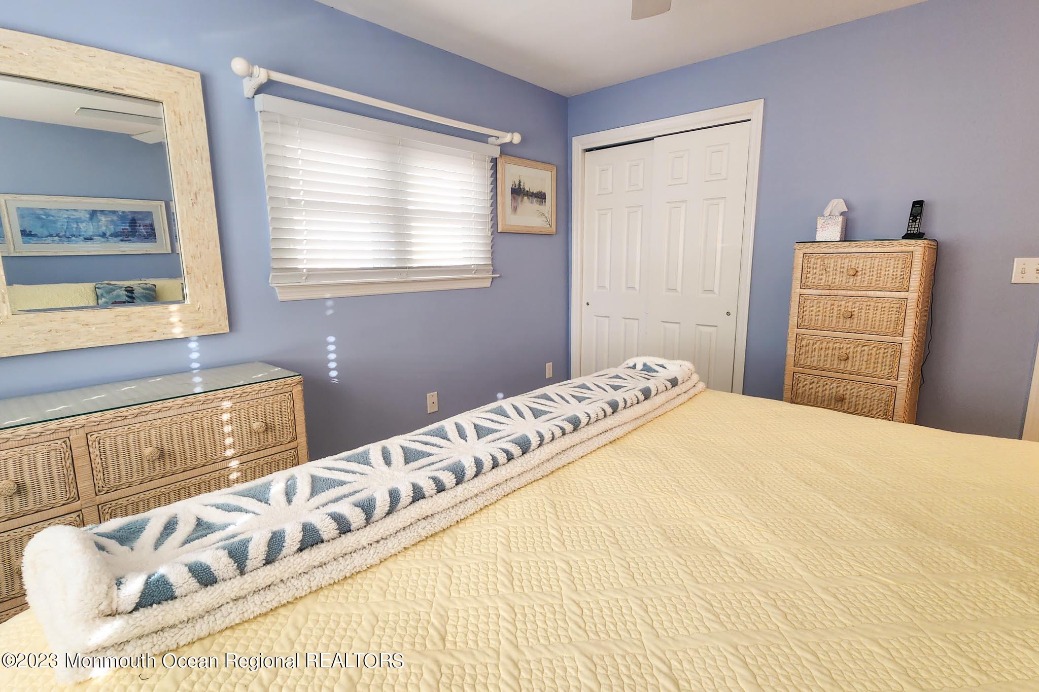 54 Silver Beach Road Lavallette, NJ 08735 - Photo 30 of 49 a bedroom with a bed and a window