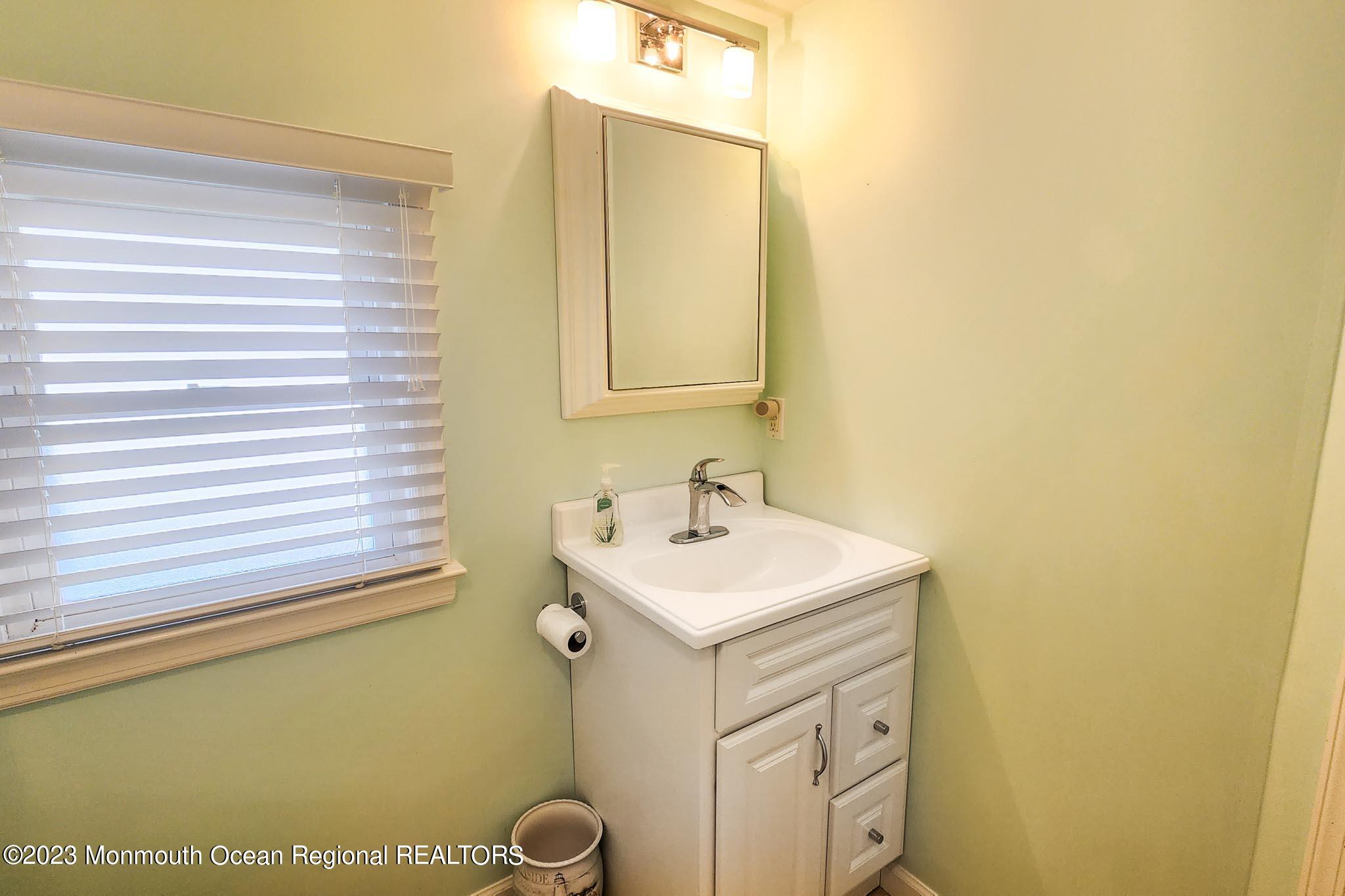 54 Silver Beach Road Lavallette, NJ 08735 - Photo 33 of 49 a bathroom with a sink and a mirror