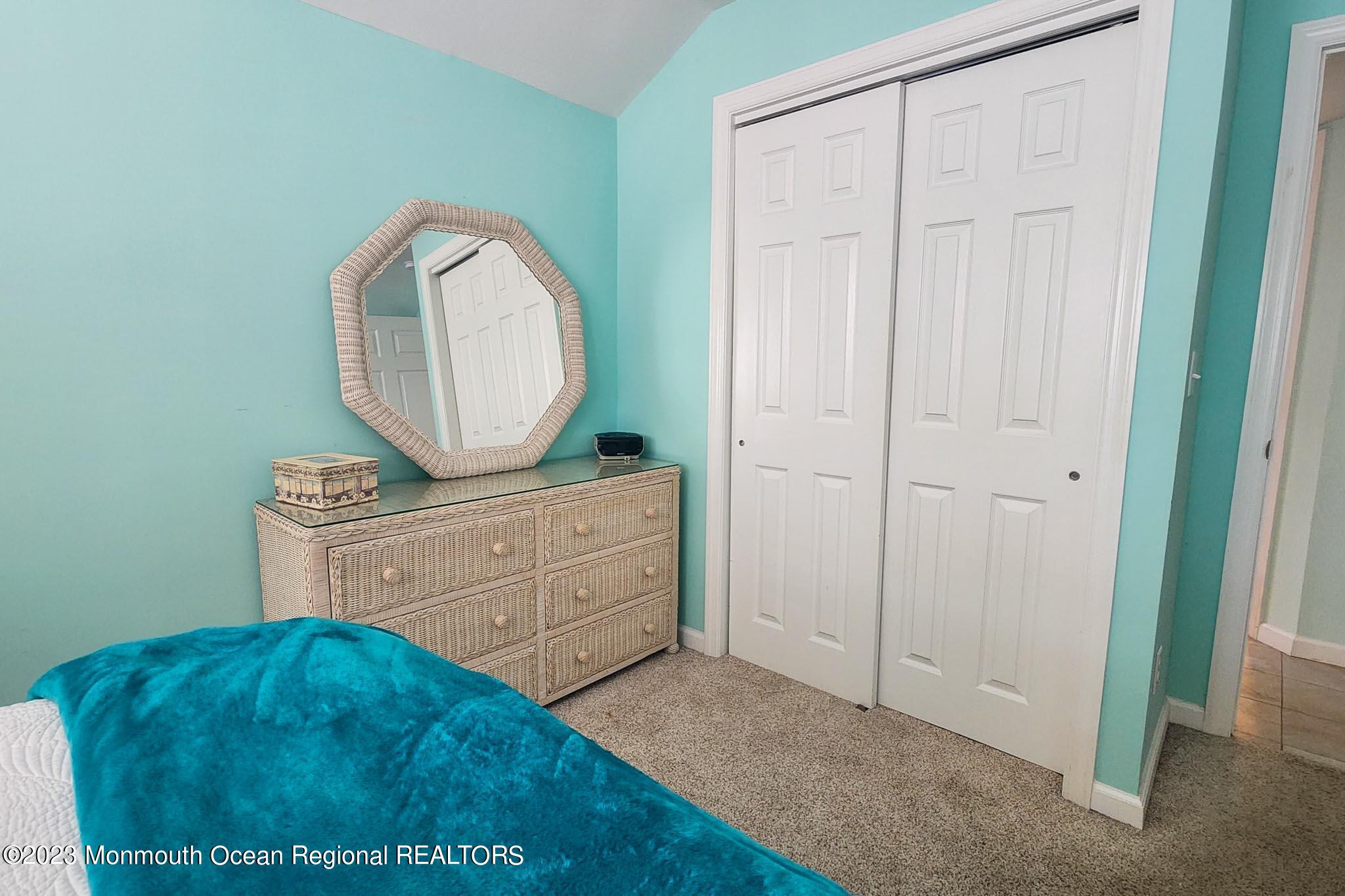 54 Silver Beach Road Lavallette, NJ 08735 - Photo 35 of 49 a room with a bed and a dresser