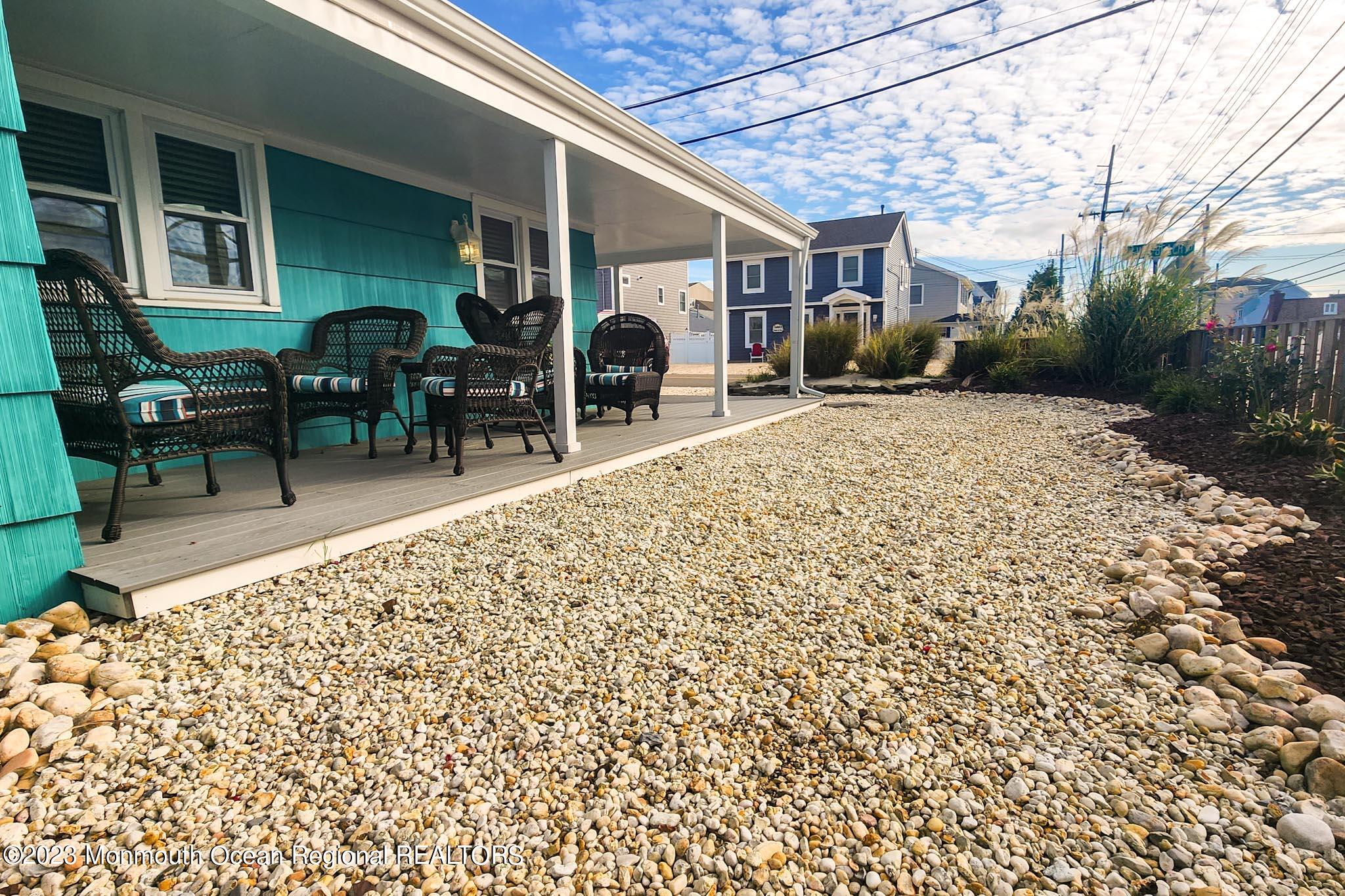 54 Silver Beach Road Lavallette, NJ 08735 - Photo 37 of 49 a backyard of a house with table and chairs