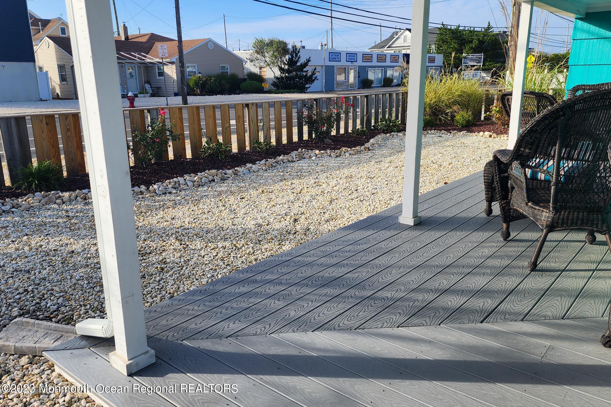 54 Silver Beach Road Lavallette, NJ 08735 - Photo 41 of 49 a view of a deck with a floor to ceiling window wooden fence