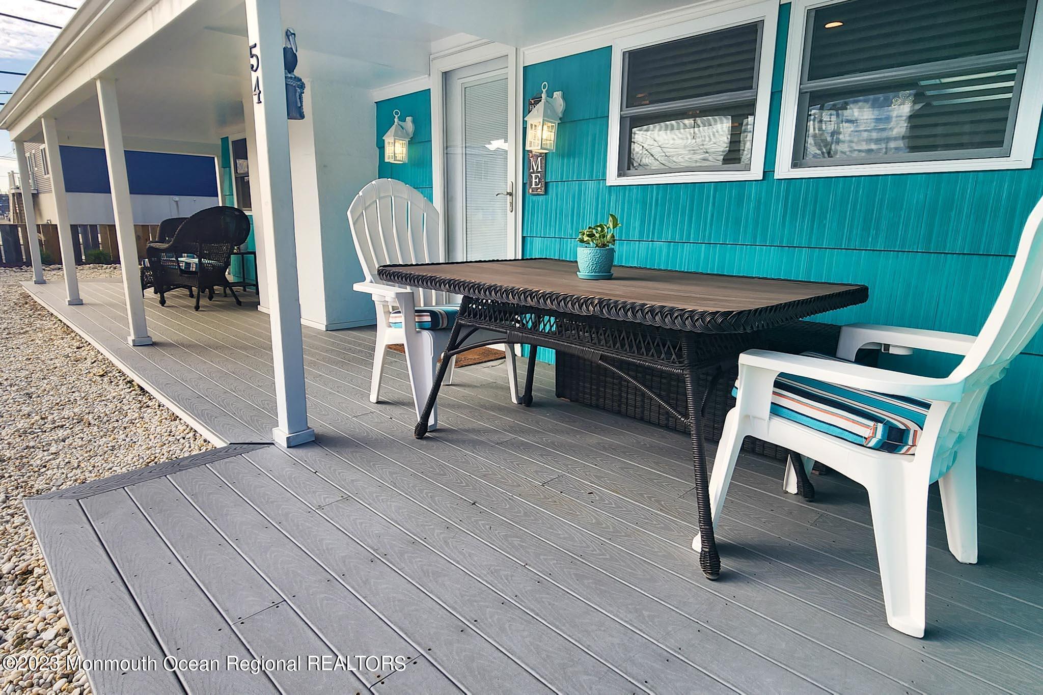 54 Silver Beach Road Lavallette, NJ 08735 - Photo 10 of 49 a view of a dinning room with wooden floor and outdoor seating