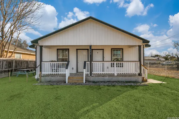 a view of a house with a yard and deck