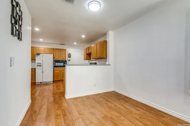 a view of a kitchen with a sink and a refrigerator