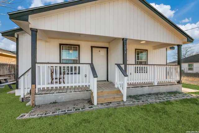 a view of a house with a yard and deck