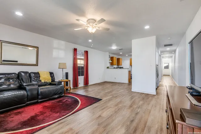a living room with furniture and kitchen view