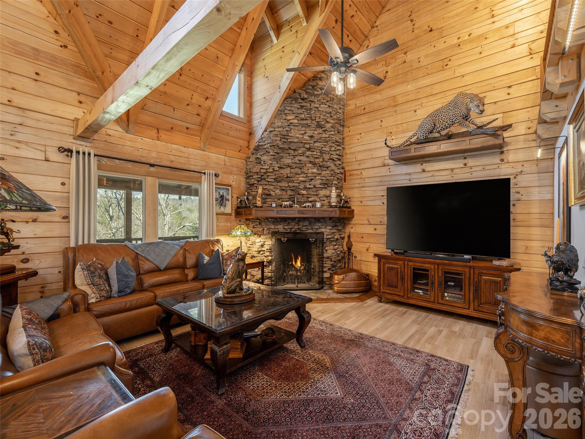 622 Oleta Road Hendersonville, NC 28792 - Photo 12 of 48 a living room with furniture a flat screen tv and a fireplace