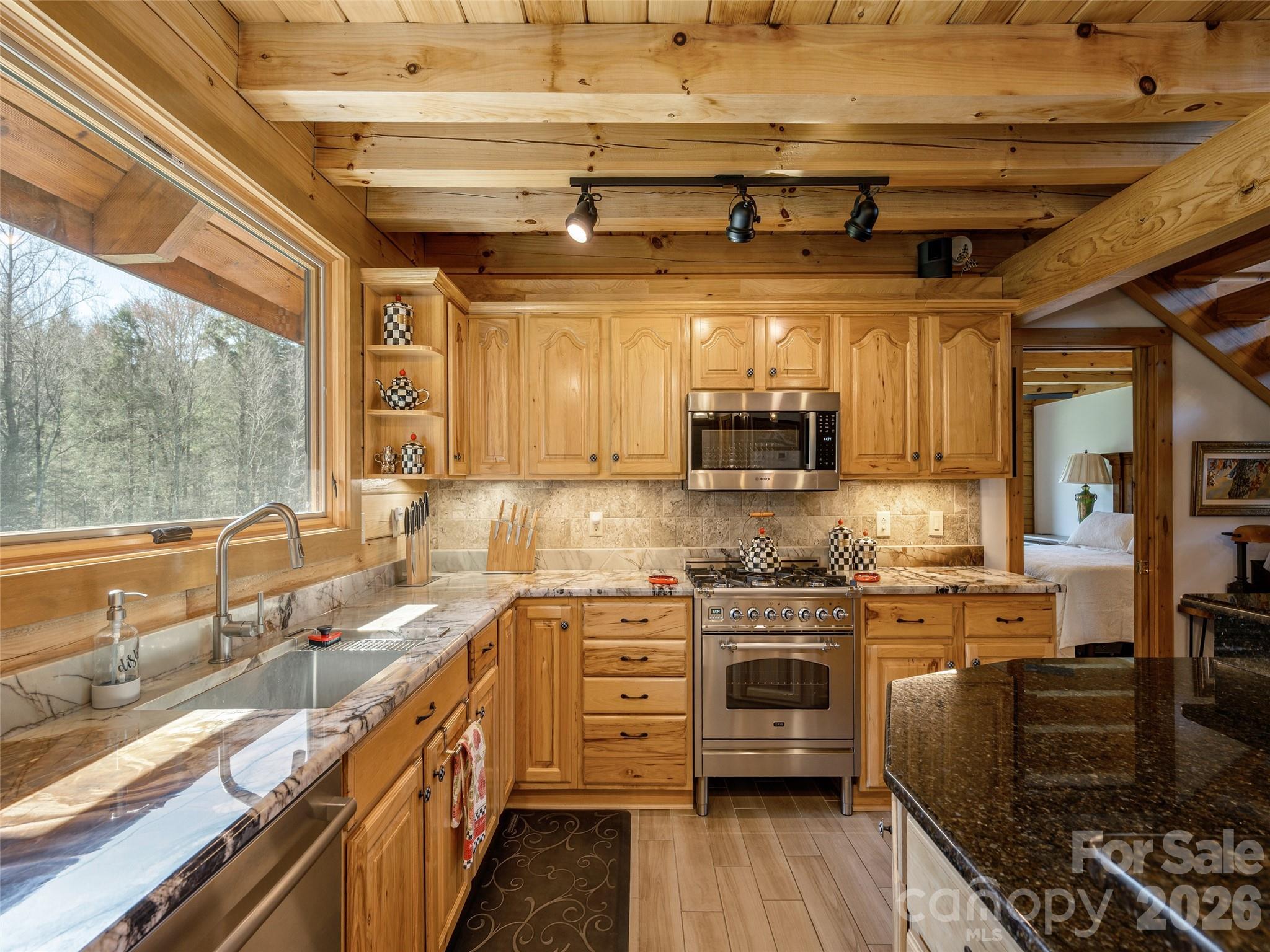 622 Oleta Road Hendersonville, NC 28792 - Photo 18 of 48 a kitchen with stainless steel appliances granite countertop a sink a stove and cabinets