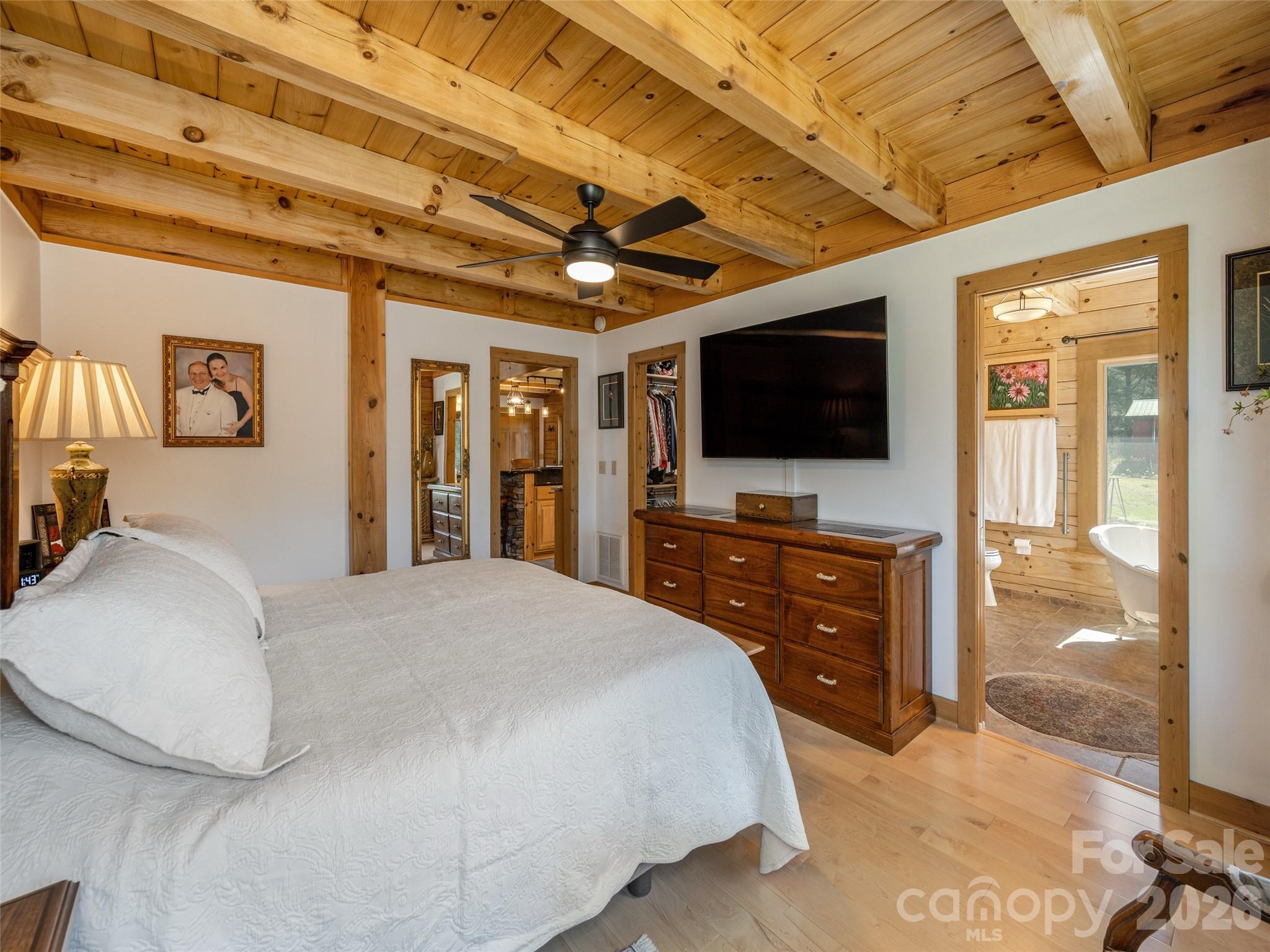 622 Oleta Road Hendersonville, NC 28792 - Photo 22 of 48 a bedroom with a bed and a flat screen tv