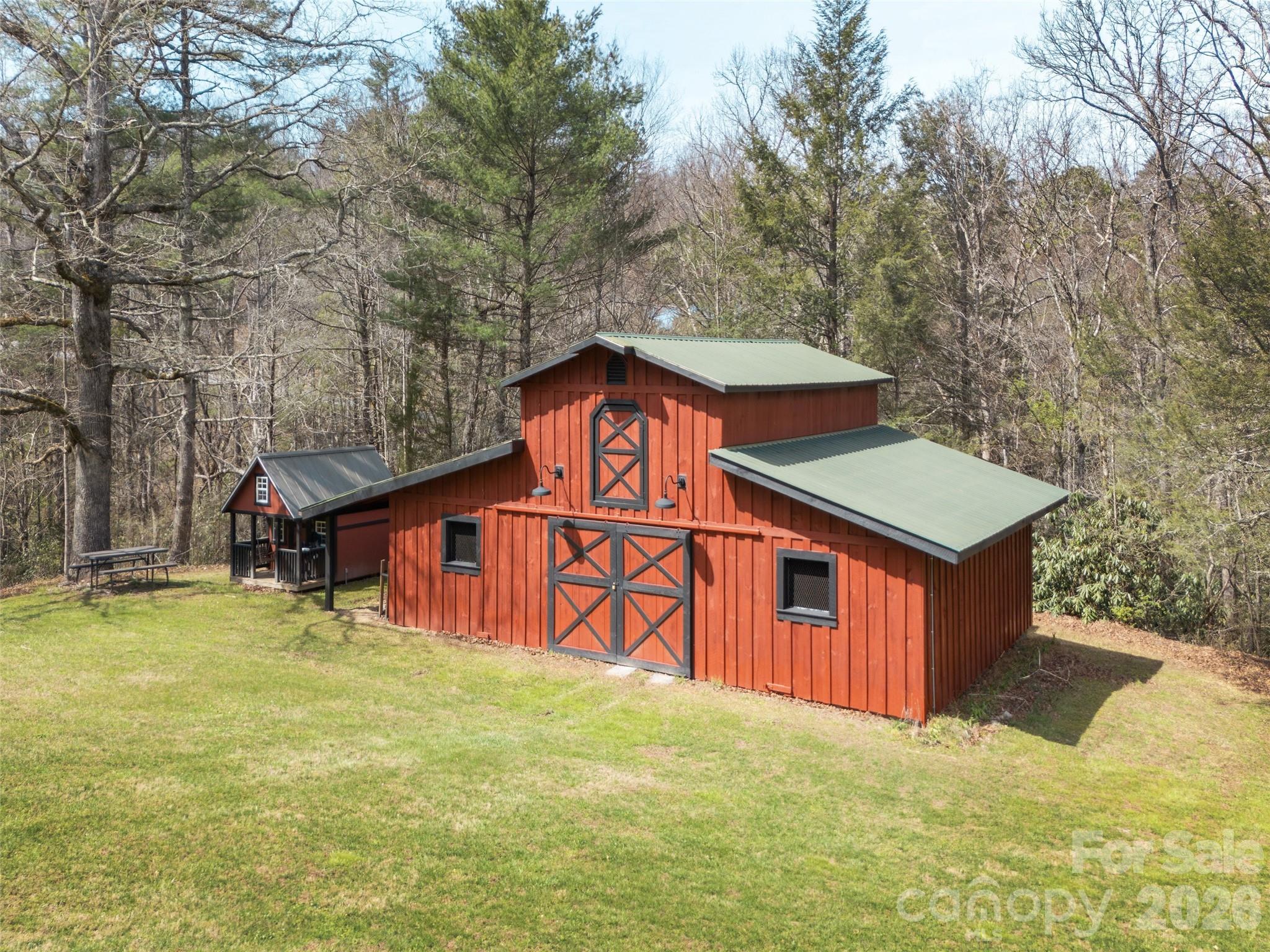 622 Oleta Road Hendersonville, NC 28792 - Photo 43 of 48 a view of a house with a big yard and large trees