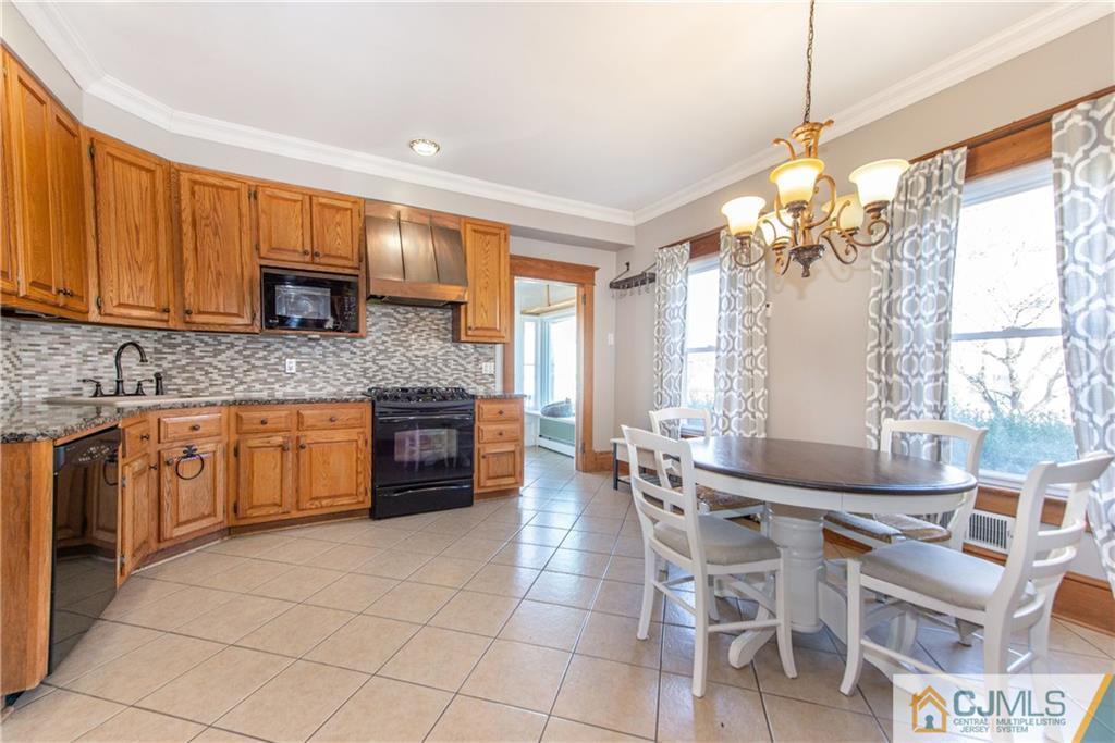 624 Ridge Road Monmouth Junction, NJ 08852 - Photo 2 of 15 a kitchen with stainless steel appliances granite countertop a stove top oven a sink a counter top space and cabinets