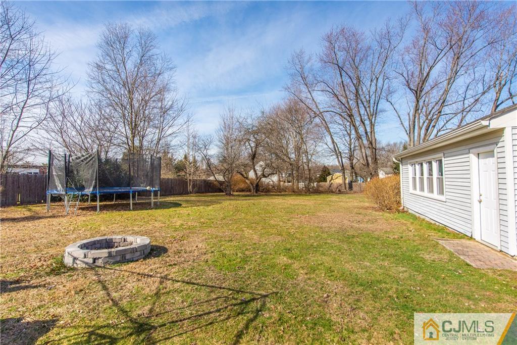 624 Ridge Road Monmouth Junction, NJ 08852 - Photo 14 of 15 a view of swimming pool with trees in front of house