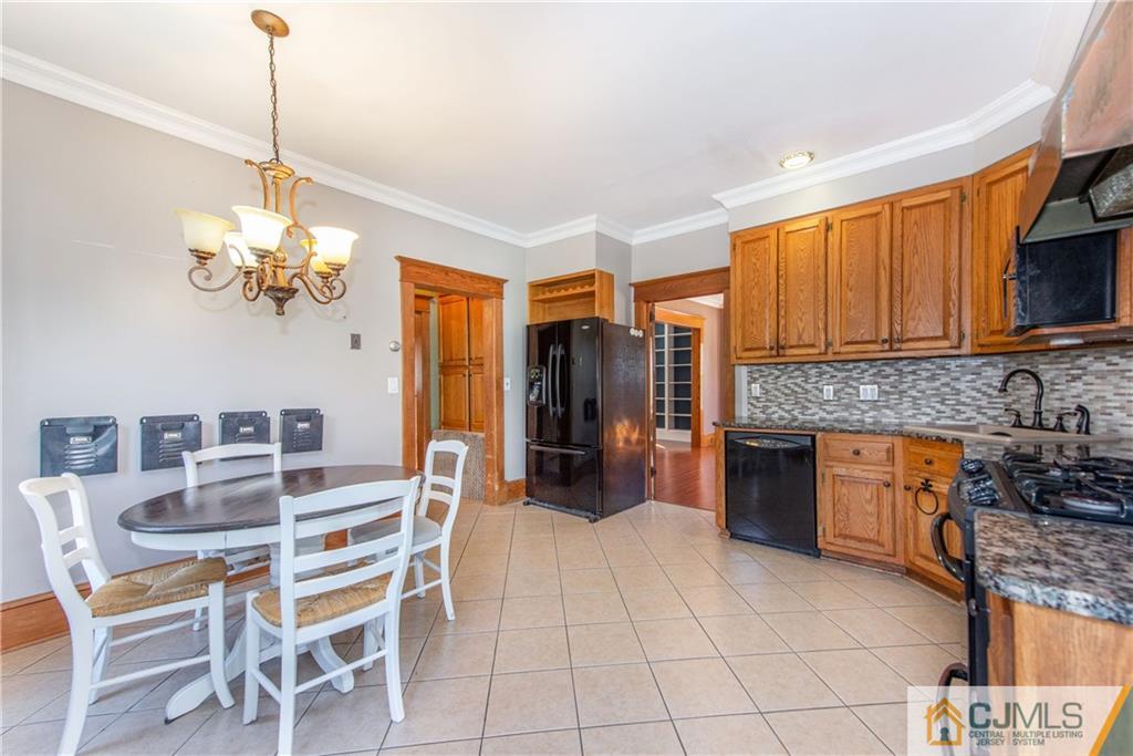 624 Ridge Road Monmouth Junction, NJ 08852 - Photo 3 of 15 a dining room filled chandelier and kitchen view