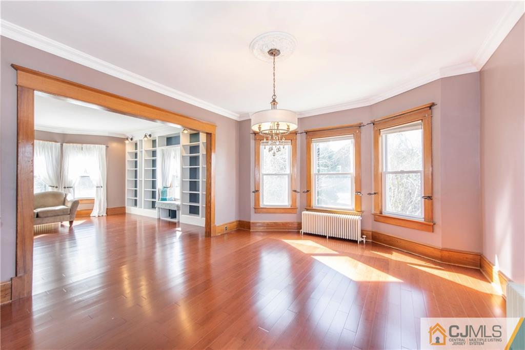 624 Ridge Road Monmouth Junction, NJ 08852 - Photo 5 of 15 a view of an empty room with wooden floor and a window