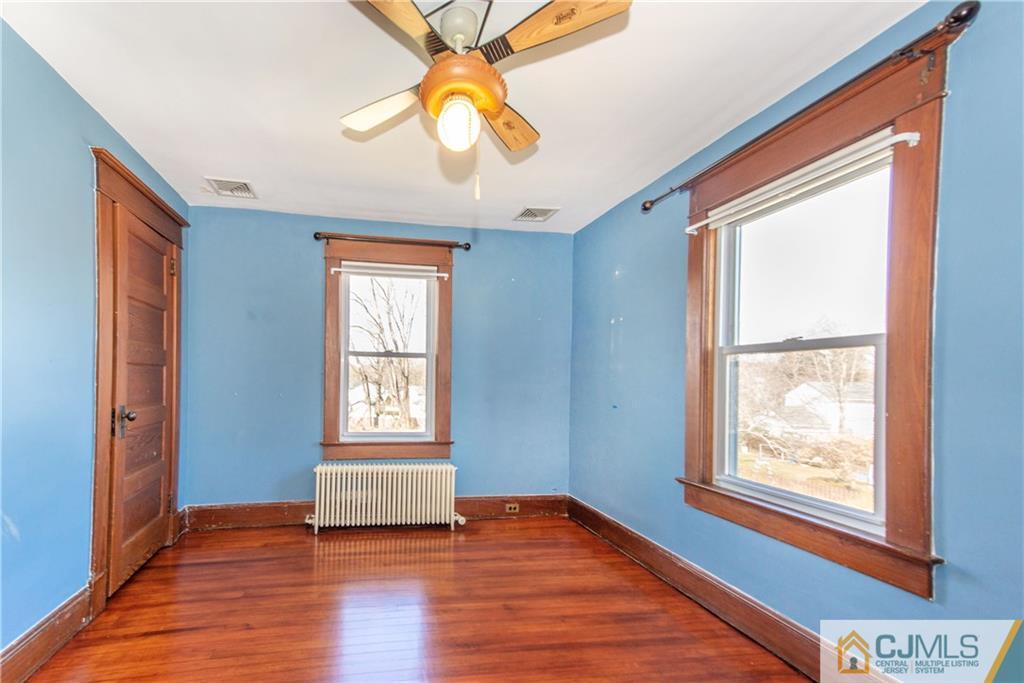 624 Ridge Road Monmouth Junction, NJ 08852 - Photo 8 of 15 an empty room with wooden floor and windows