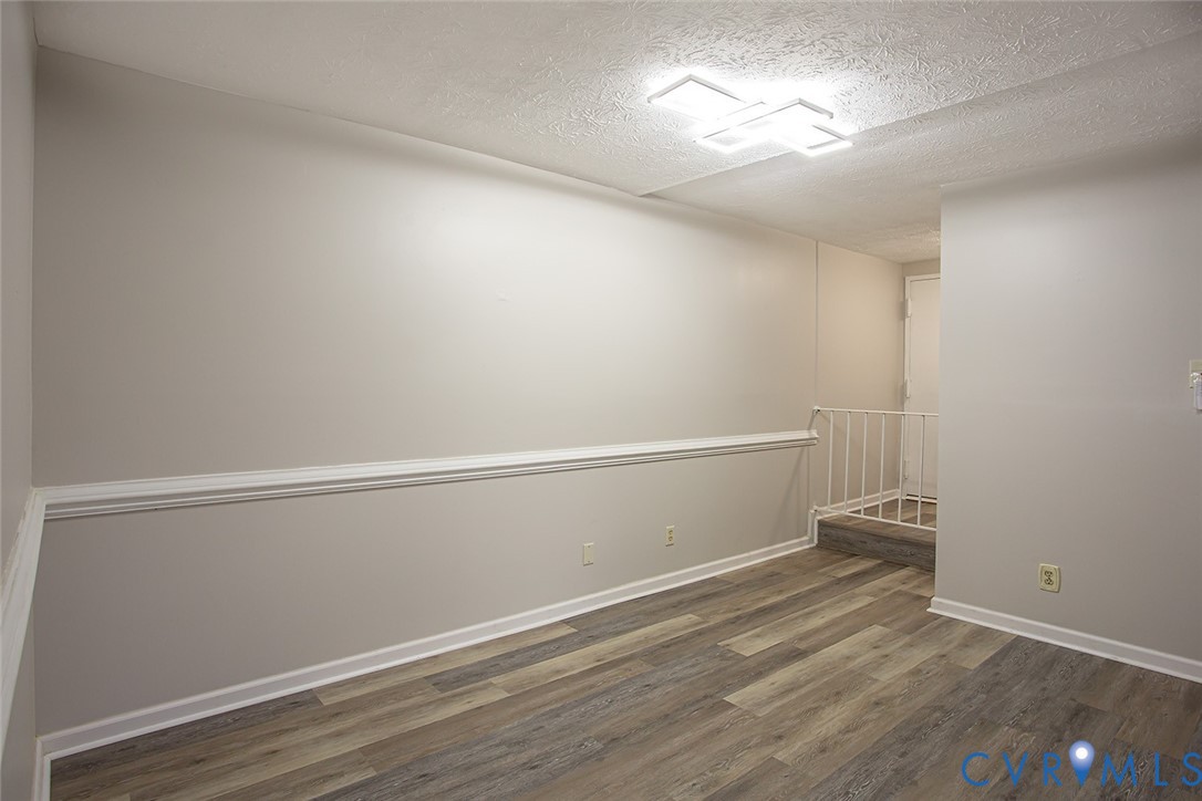 1500 Largo Road, Unit 201 Henrico, VA 23238 - Photo 12 of 26 Empty room featuring dark wood-style flooring and