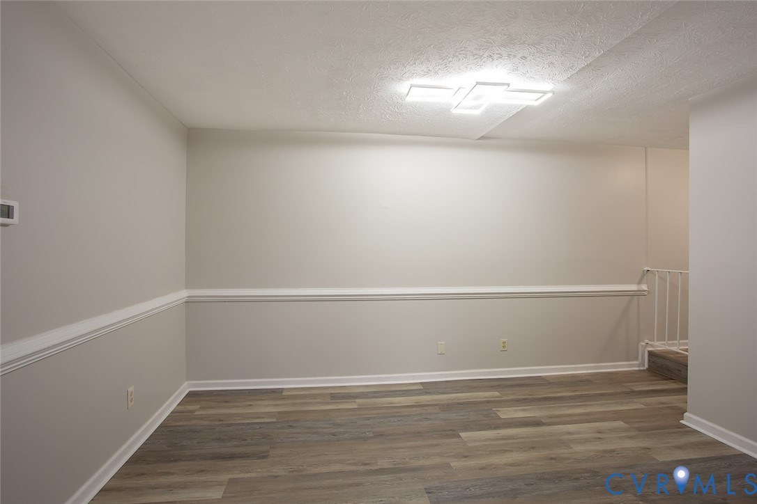 1500 Largo Road, Unit 201 Henrico, VA 23238 - Photo 13 of 26 Empty room featuring wood finished floors and a te