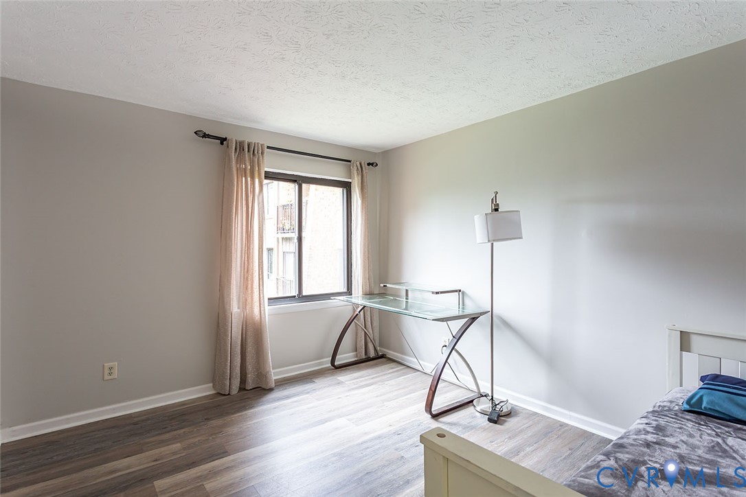 1500 Largo Road, Unit 201 Henrico, VA 23238 - Photo 15 of 23 Bedroom with a textured ceiling and wood finished