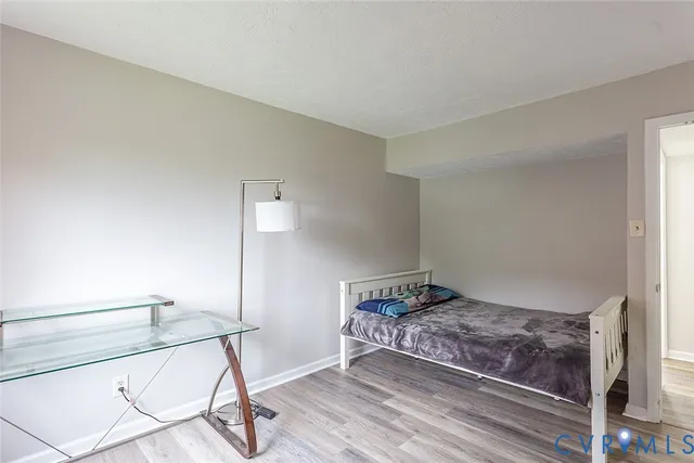 a bedroom with a bed and lamp with window