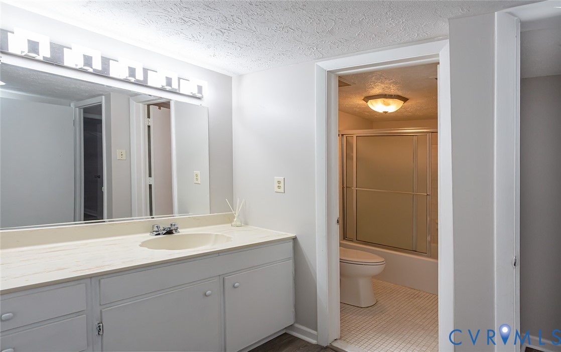 1500 Largo Road, Unit 201 Henrico, VA 23238 - Photo 17 of 23 Bathroom with a textured ceiling, vanity, and bath