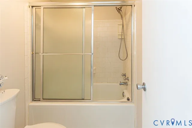 a bathroom with a glass shower door