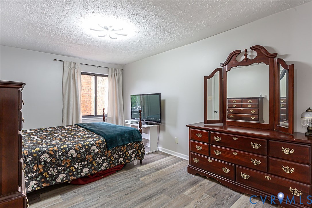 1500 Largo Road, Unit 201 Henrico, VA 23238 - Photo 23 of 26 Bedroom featuring a textured ceiling and light woo