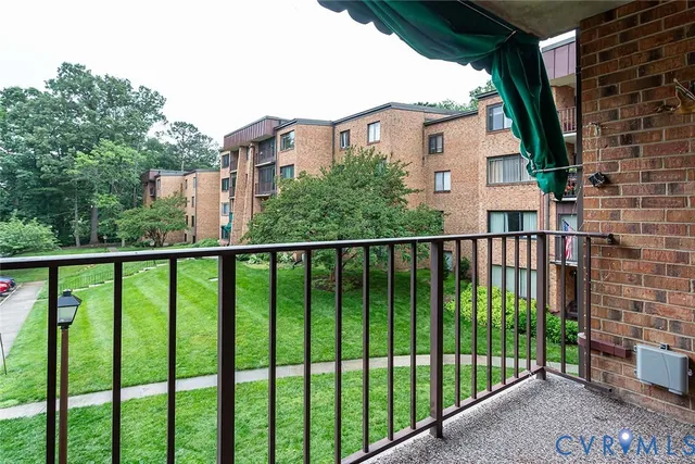 a view of a balcony with a floor to ceiling window and wooden fence