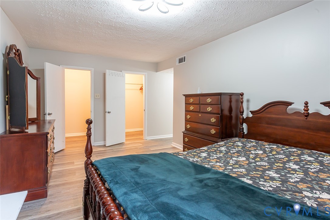 1500 Largo Road, Unit 201 Henrico, VA 23238 - Photo 25 of 26 Bedroom with a textured ceiling, light wood-type f