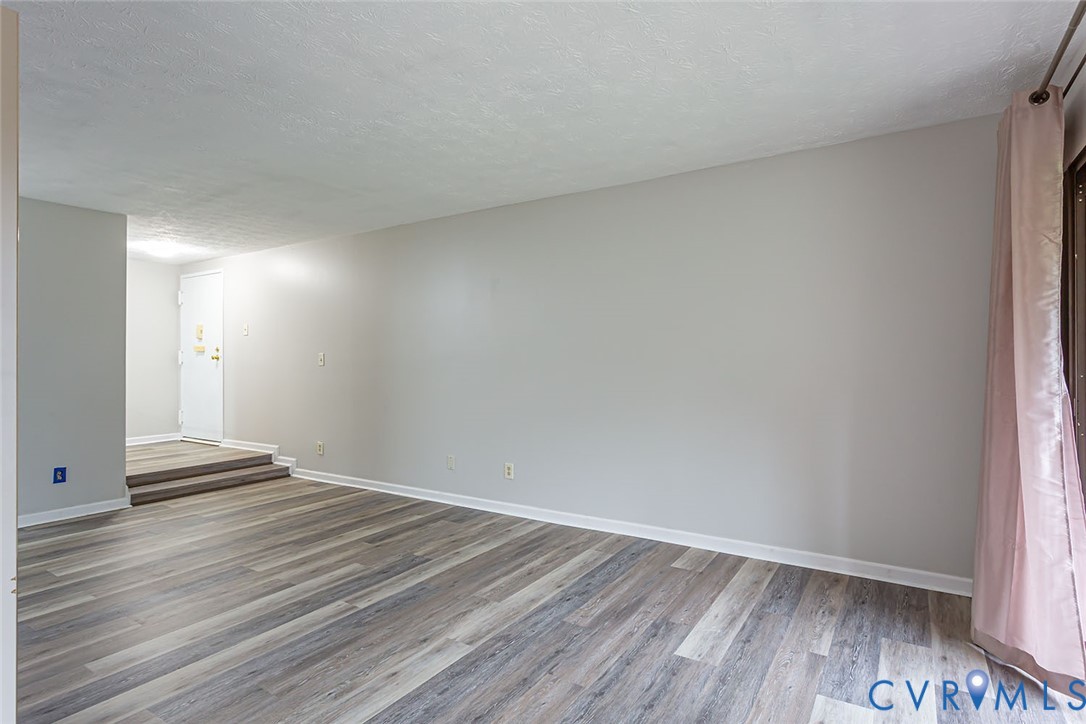 1500 Largo Road, Unit 201 Henrico, VA 23238 - Photo 5 of 26 Empty room with a textured ceiling and wood finish