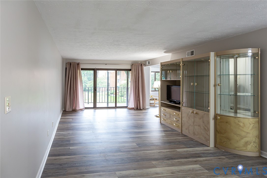 1500 Largo Road, Unit 201 Henrico, VA 23238 - Photo 6 of 26 Unfurnished living room featuring a textured ceili