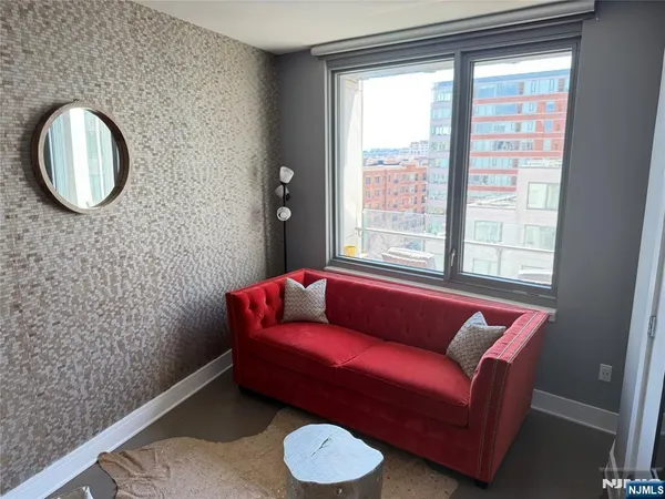 a blue room with a couch and a window