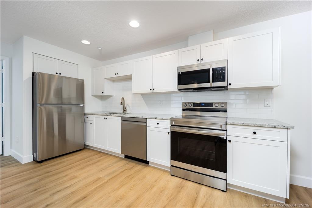 3375 Southwest Mapp Road, Unit 204 Palm City, FL 34990 - Photo 2 of 17 a kitchen with a refrigerator stove and microwave