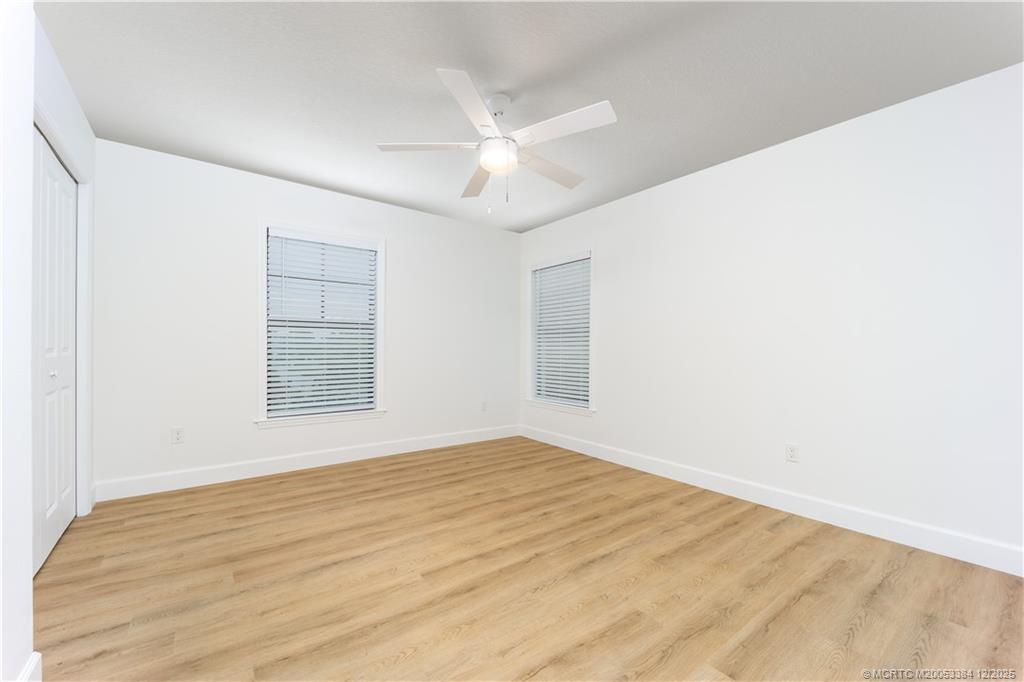 3375 Southwest Mapp Road, Unit 204 Palm City, FL 34990 - Photo 7 of 17 a view of an empty room with wooden floor and a window
