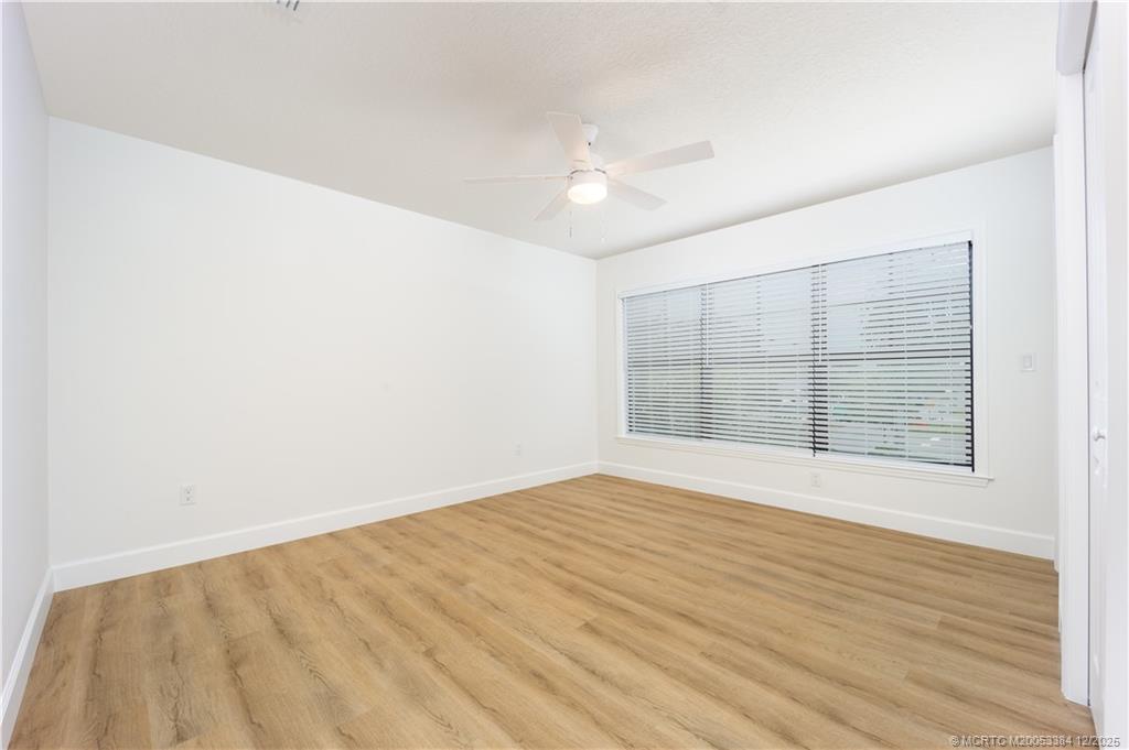 3375 Southwest Mapp Road, Unit 204 Palm City, FL 34990 - Photo 10 of 17 an empty room with wooden floor and windows
