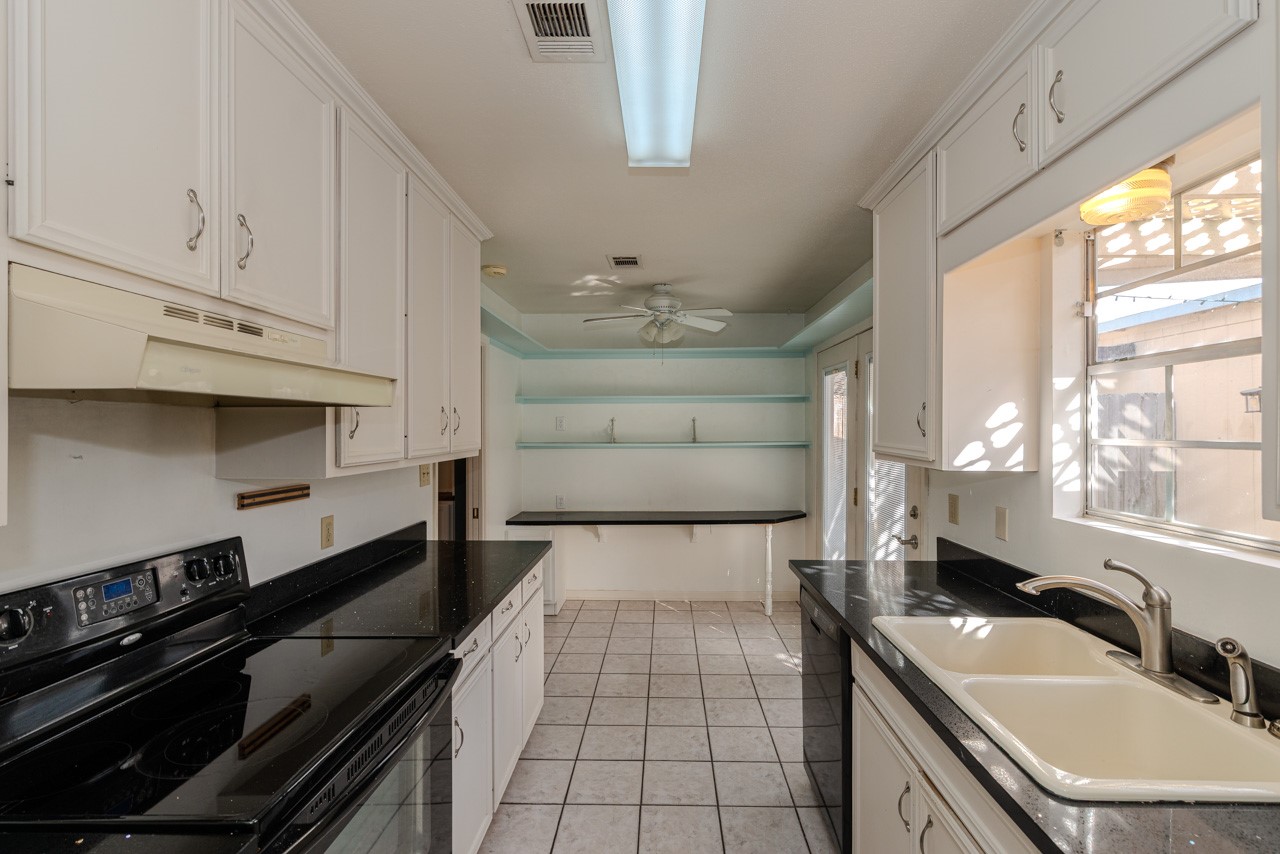 5975 Meadow Way Beaumont, TX 77707 - Photo 8 of 18 a large kitchen with kitchen island a sink stainless steel appliances and cabinets