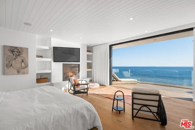 a bedroom with furniture and a fireplace