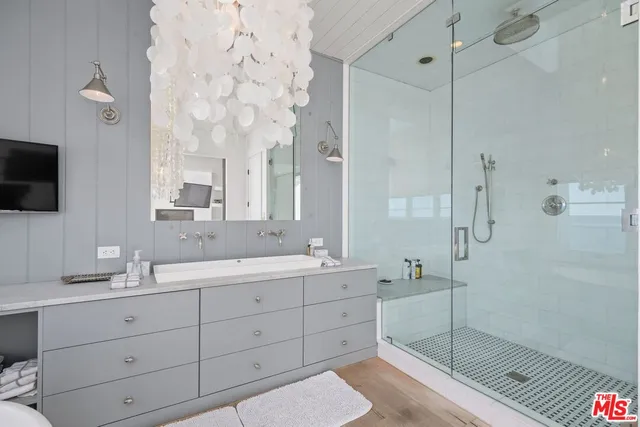 a bathroom with a double vanity sink mirror and shower