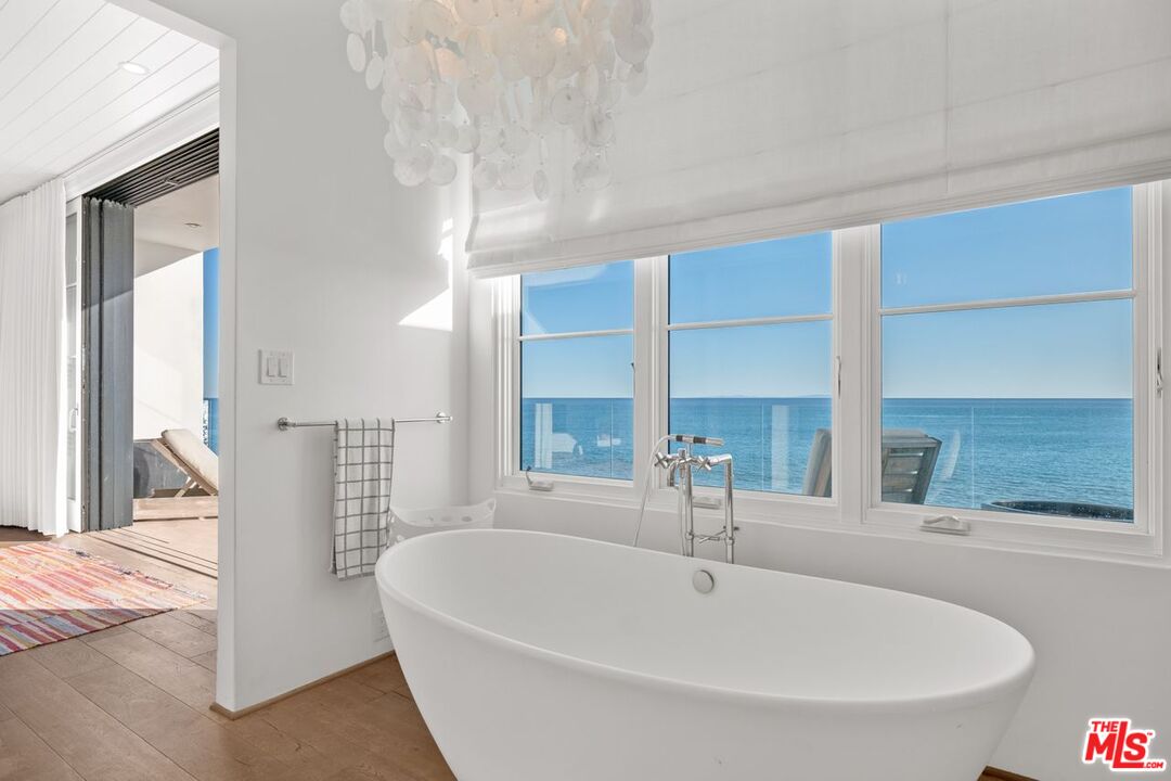 27212 Escondido Beach Road Malibu, CA 90265 - Photo 19 of 34 a white bath tub sitting in a bathroom next to a window