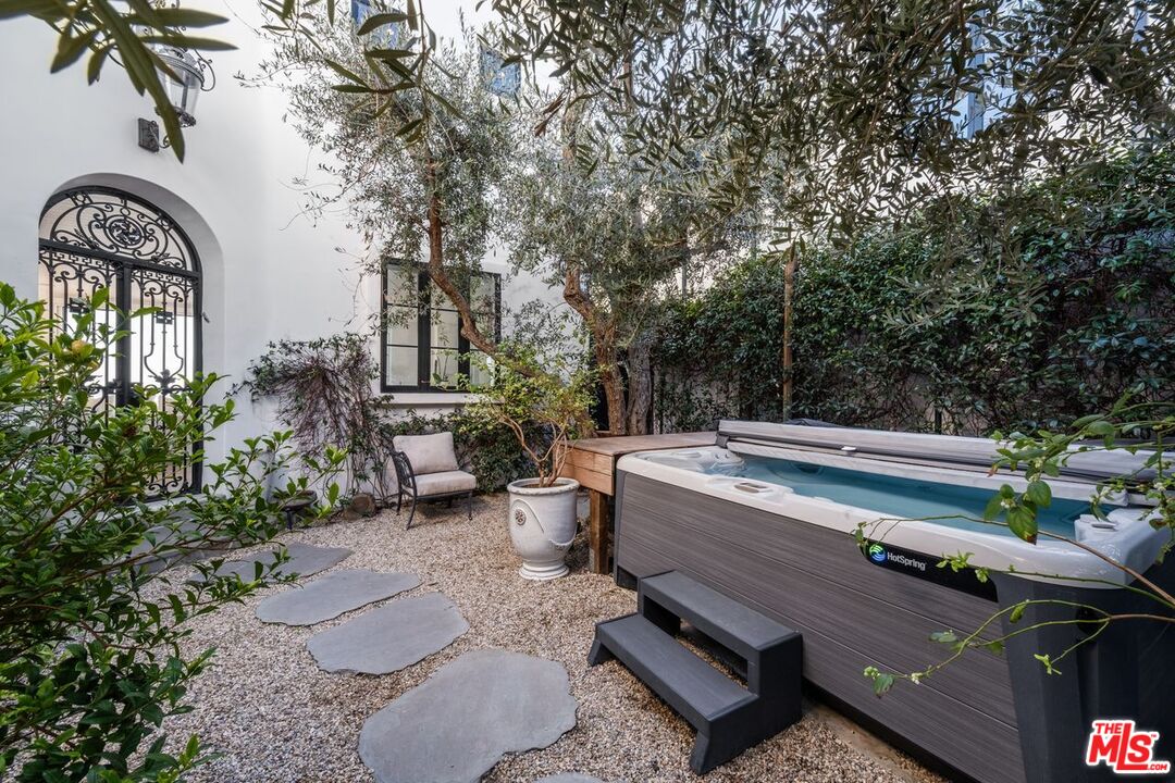 27212 Escondido Beach Road Malibu, CA 90265 - Photo 5 of 34 a view of a patio with couches a table and chairs and potted plants