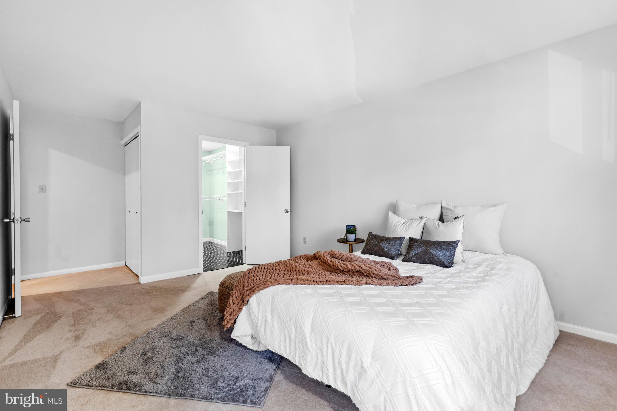 7512 Rolling Road Springfield, VA 22153 - Photo 13 of 32 a bedroom with a bed and a mirror